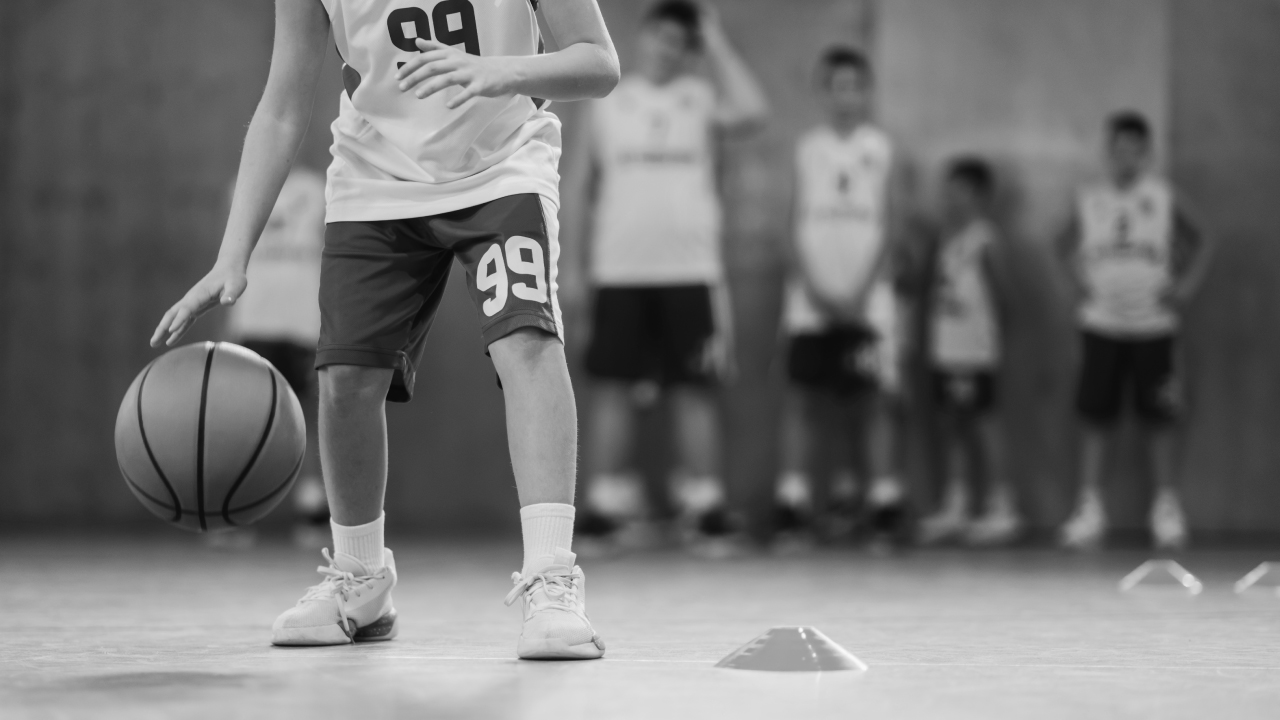 youth basketball players participating in dribbling drills