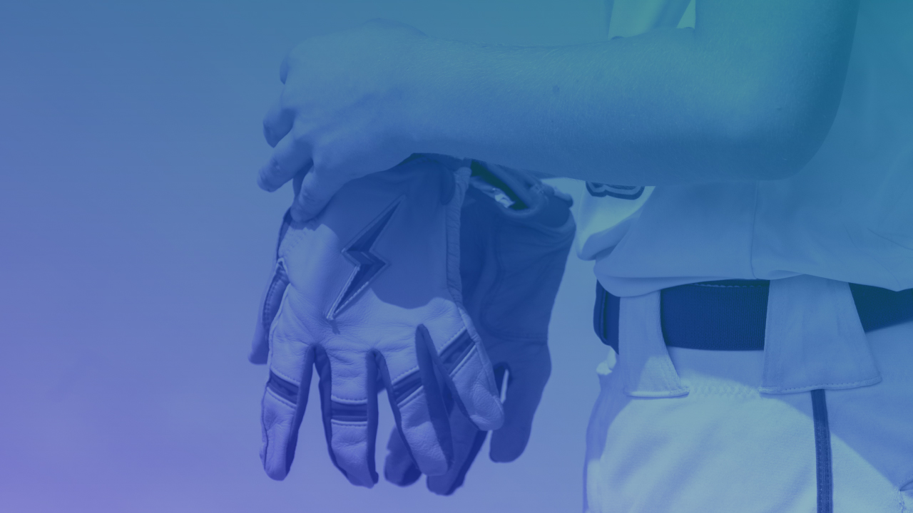 youth baseball player holding batting gloves