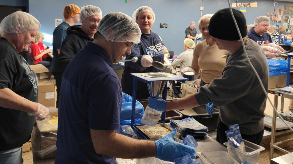 MYAS staff helping pack meals for Feed Our Starving Children